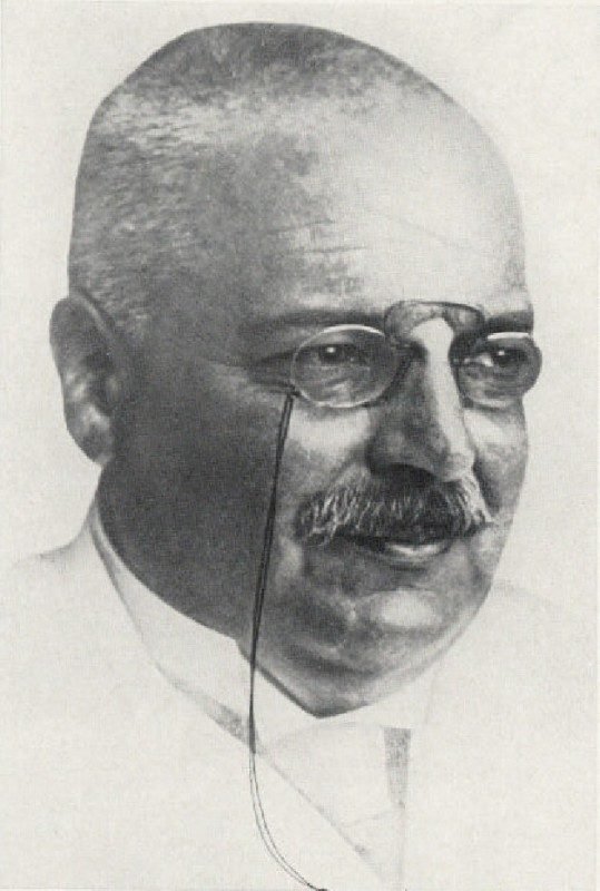 Portrait photograph of a man with a moustache and pince-nez glasses.