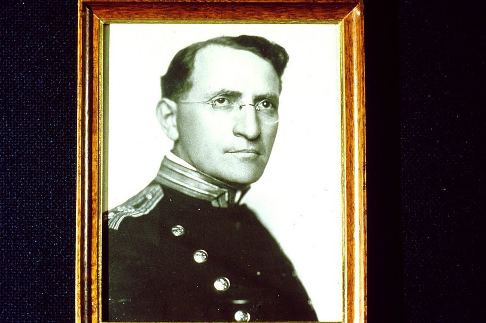 Old photograph of Dr. Joseph Goldberger in a suit, seated at a desk.